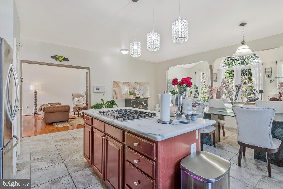 215 Hoile Lane Huntingtown, MD 20639 - Photo 17 of 52 a view of kitchen island dining table and chairs