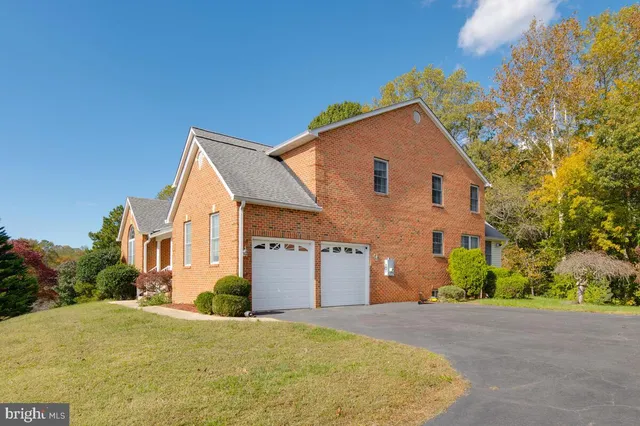 a view of a house with a yard and garage
