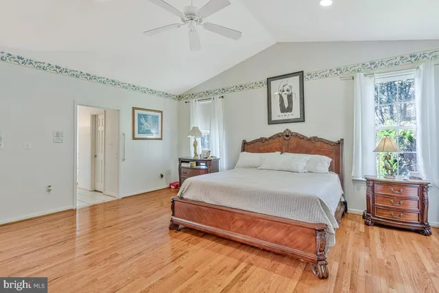 a bedroom with a bed and a wooden floor