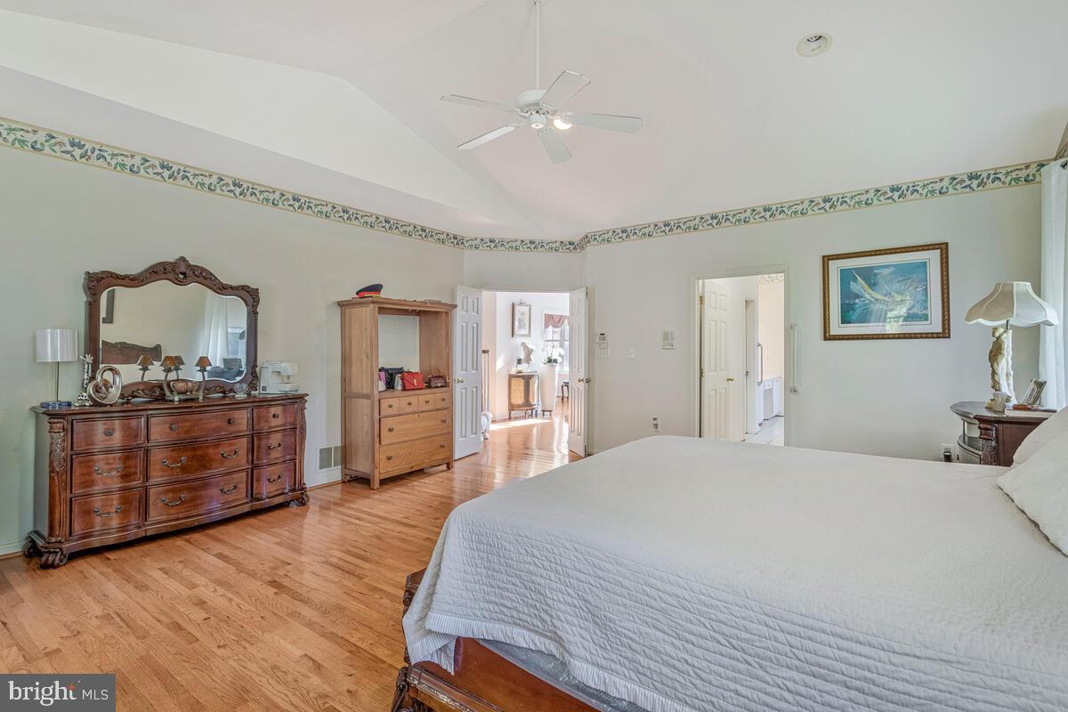 215 Hoile Lane Huntingtown, MD 20639 - Photo 25 of 52 a bedroom with a bed and wooden floor