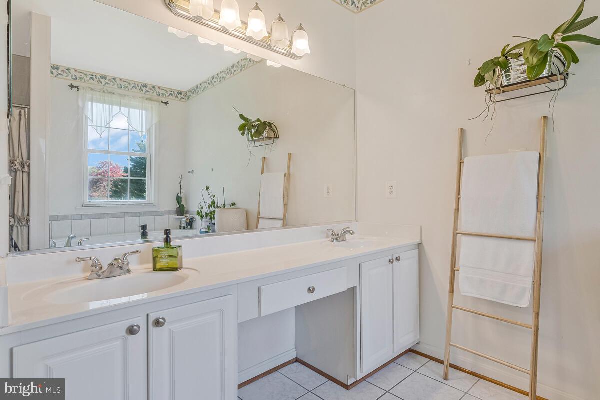215 Hoile Lane Huntingtown, MD 20639 - Photo 26 of 52 a bathroom with a sink a mirror and a shower