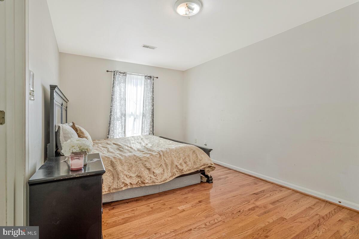 215 Hoile Lane Huntingtown, MD 20639 - Photo 32 of 52 a bedroom with a bed and wooden floor