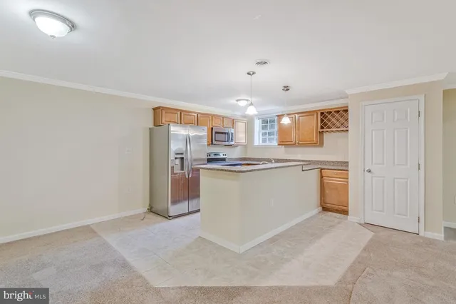a kitchen with granite countertop cabinets stainless steel appliances and a sink