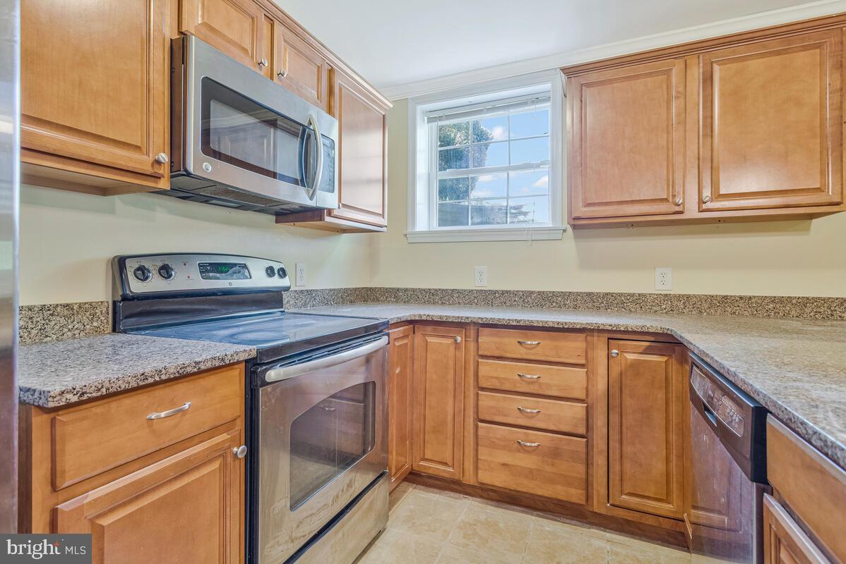 215 Hoile Lane Huntingtown, MD 20639 - Photo 38 of 52 a kitchen with granite countertop cabinets stainless steel appliances and a sink
