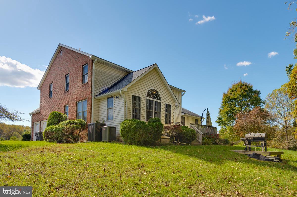 215 Hoile Lane Huntingtown, MD 20639 - Photo 4 of 52 a front view of house with yard and trees in the background