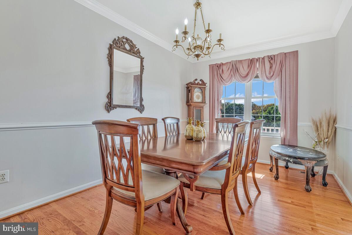 215 Hoile Lane Huntingtown, MD 20639 - Photo 8 of 52 a view of a dining room with furniture window and wooden floor