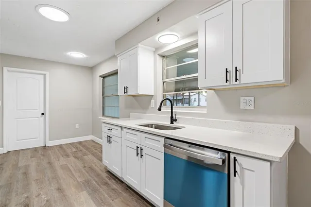 a kitchen with a sink cabinets and appliances