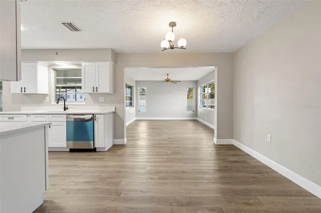 a view of a kitchen with a sink cabinets and wooden floor