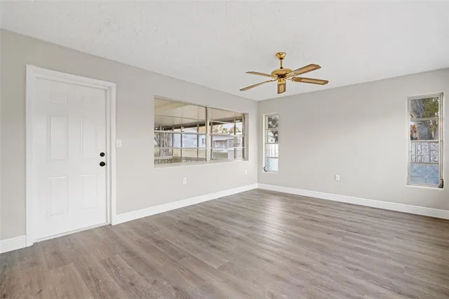 a view of a livingroom with a window and wooden floor