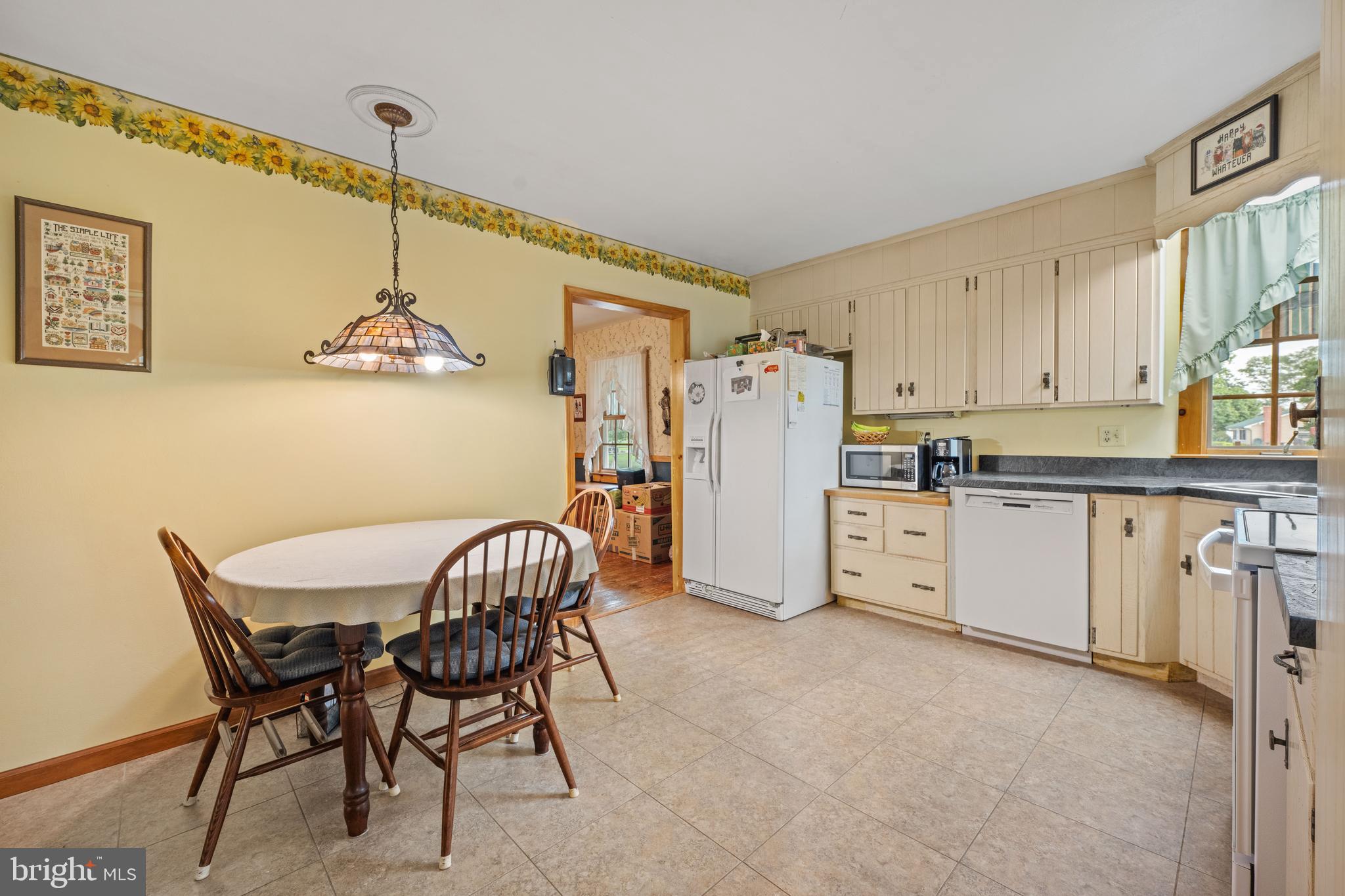 291 Acton Station Road Salem, NJ 08079 - Photo 29 of 45 a kitchen with refrigerator a table and chairs
