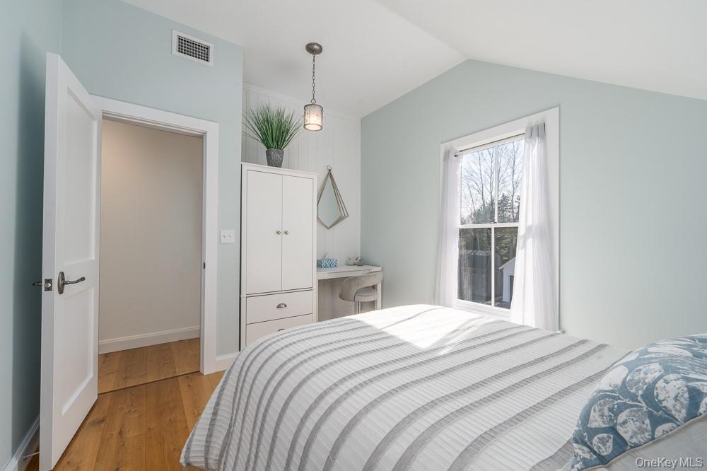 19000 Main Road Mattituck, NY 11952 - Photo 23 of 32 Bedroom with light wood-style flooring, lofted ceiling, and baseboards