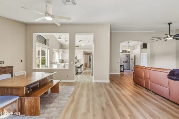 a living room with furniture a wooden floor and chandelier