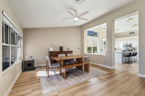 a living room with furniture a table and wooden floor