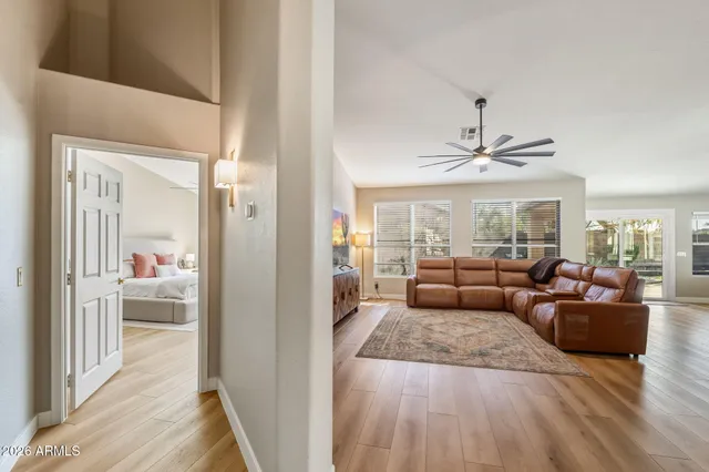 a living room with furniture and a chandelier