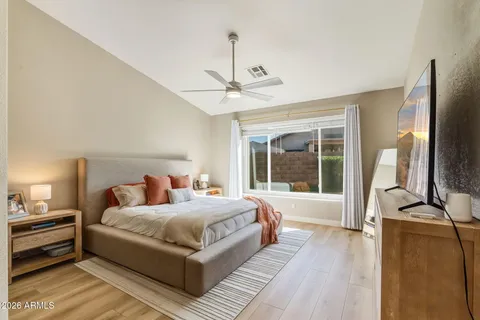 a bedroom with a large bed and a large window