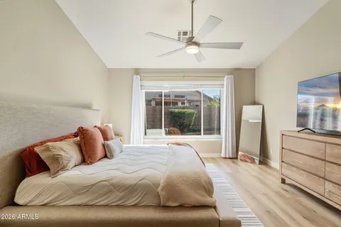 a bedroom with a large bed and a large window