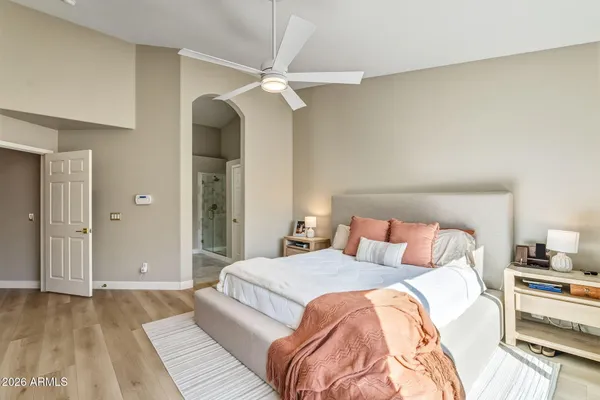 a bedroom with a bed and a chandelier