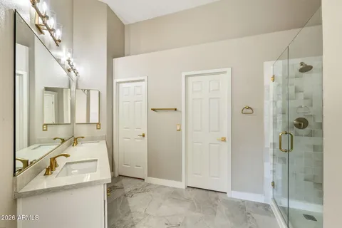 a bathroom with a granite countertop sink mirror and shower