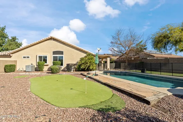 a view of a house with swimming pool and a yard