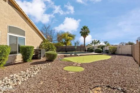 a view of a swimming pool with an outdoor seating and a yard