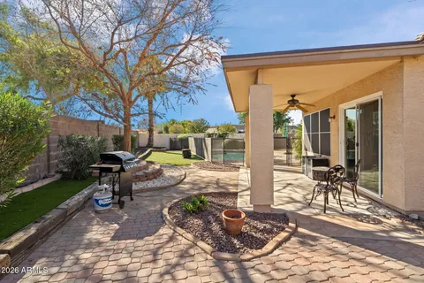 a view of a patio with table and chairs and potted plants