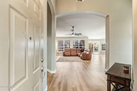 a living room with furniture and a wooden floor