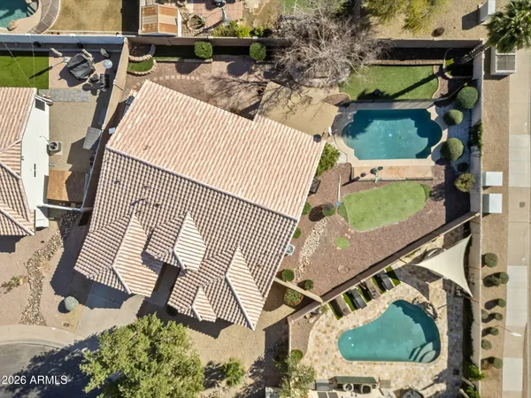 an aerial view of a house with a yard and patio