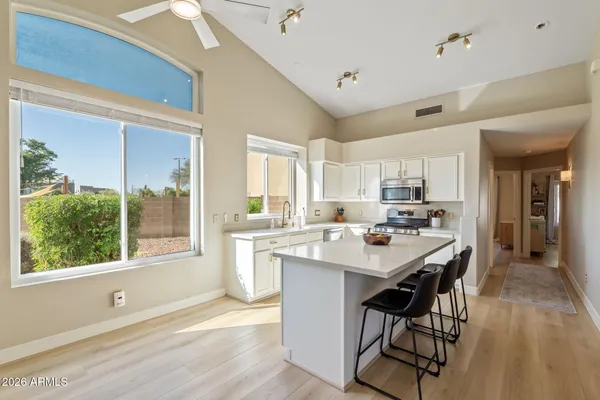 a open kitchen with a sink a counter top space and stainless steel appliances