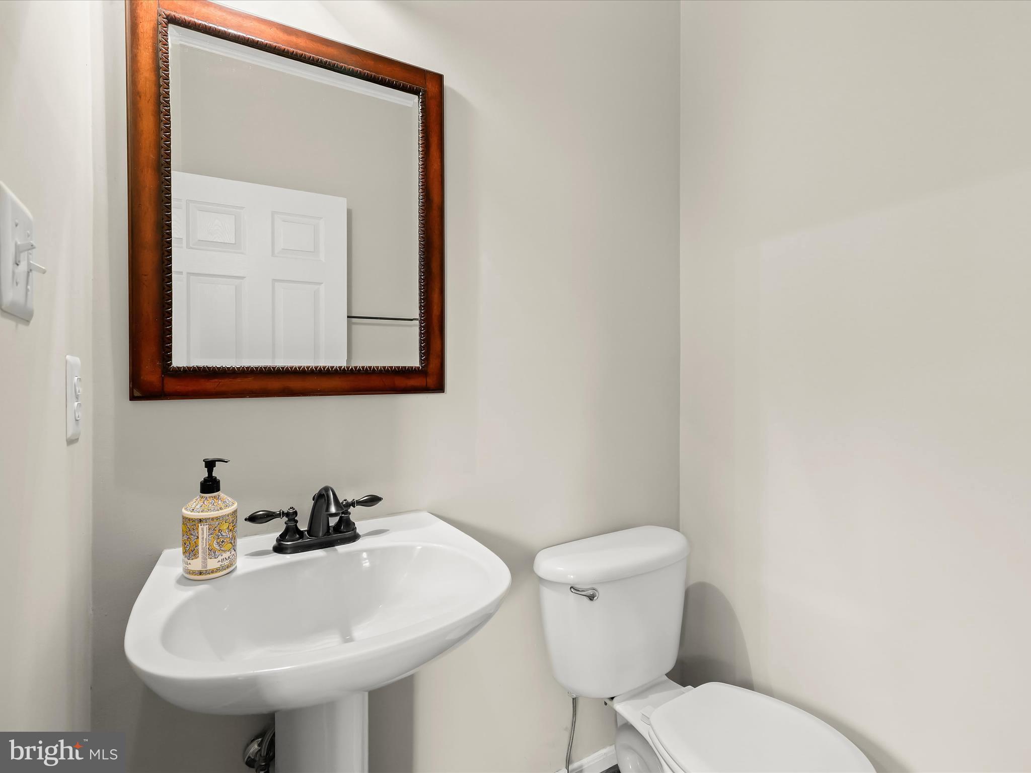 2614 Streamview Drive Odenton, MD 21113 - Photo 14 of 52 a bathroom with a toilet a sink and mirror