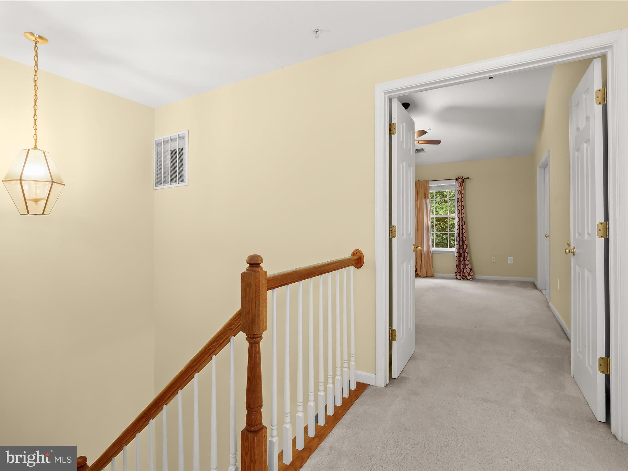 2614 Streamview Drive Odenton, MD 21113 - Photo 15 of 52 a view of a hallway with wooden floor and staircase