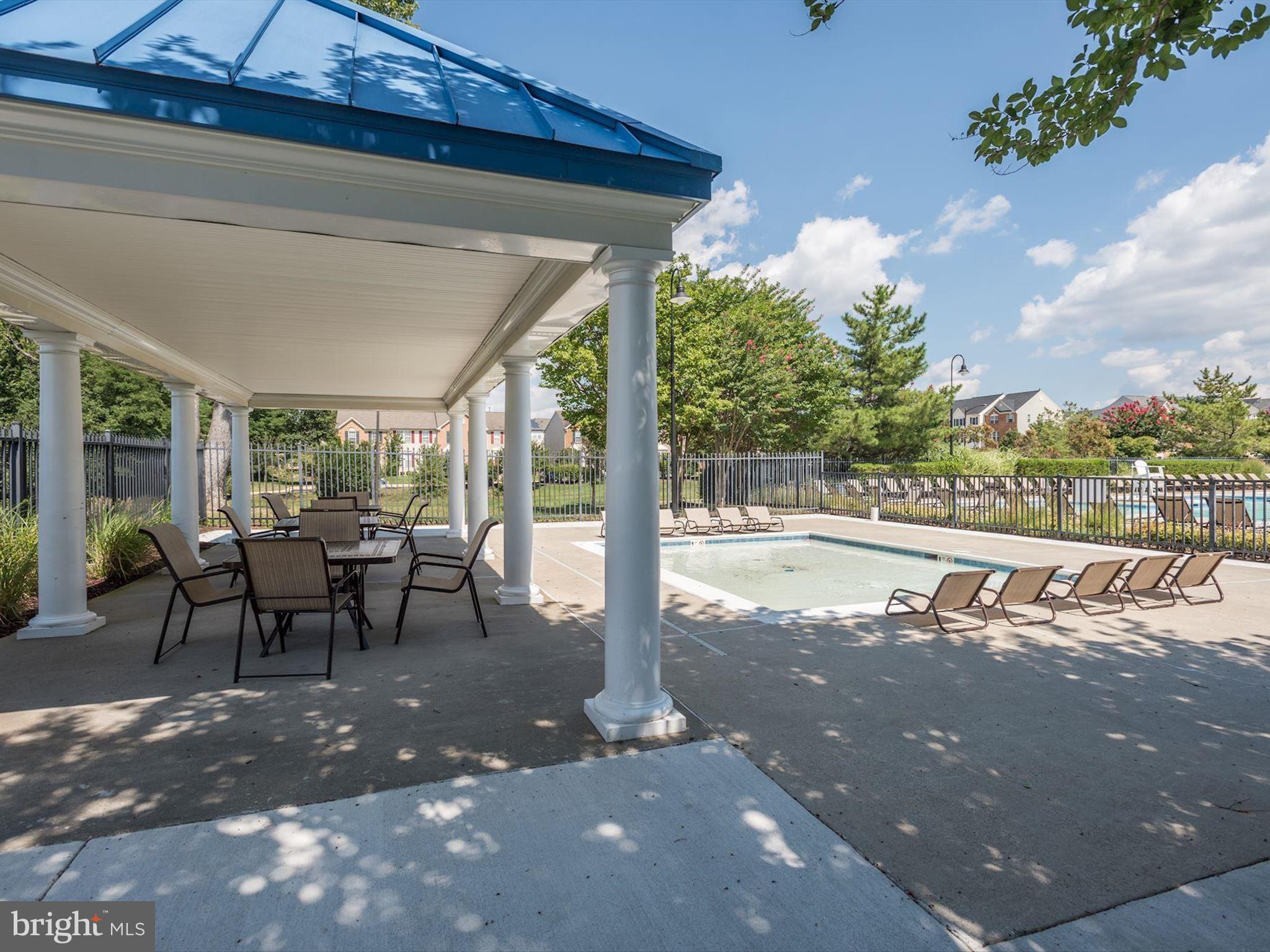 2614 Streamview Drive Odenton, MD 21113 - Photo 37 of 52 a view of a patio with table and chairs potted plants with wooden floor