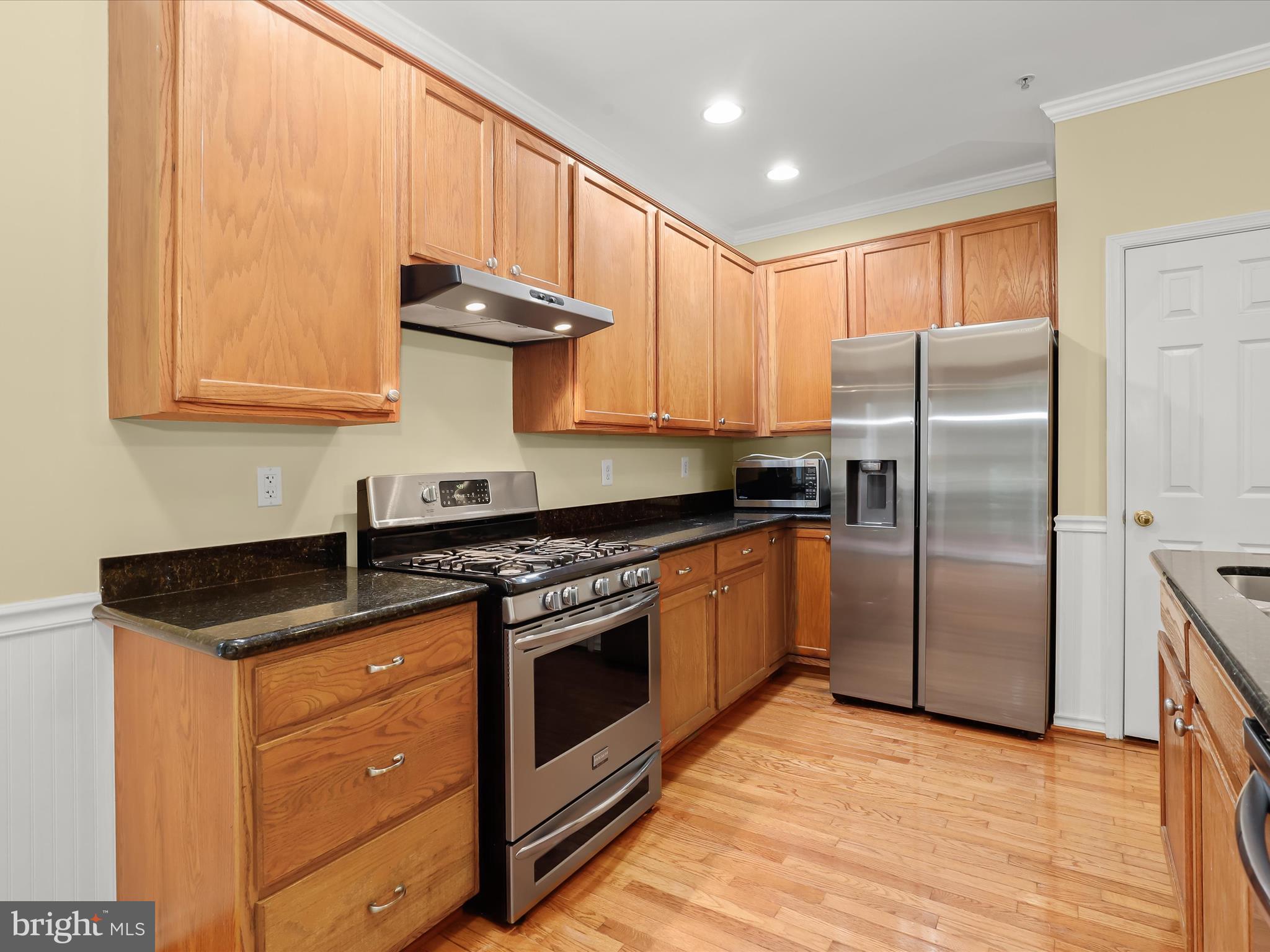 2614 Streamview Drive Odenton, MD 21113 - Photo 10 of 52 a kitchen with stainless steel appliances granite countertop a stove a refrigerator and a sink with cabinets