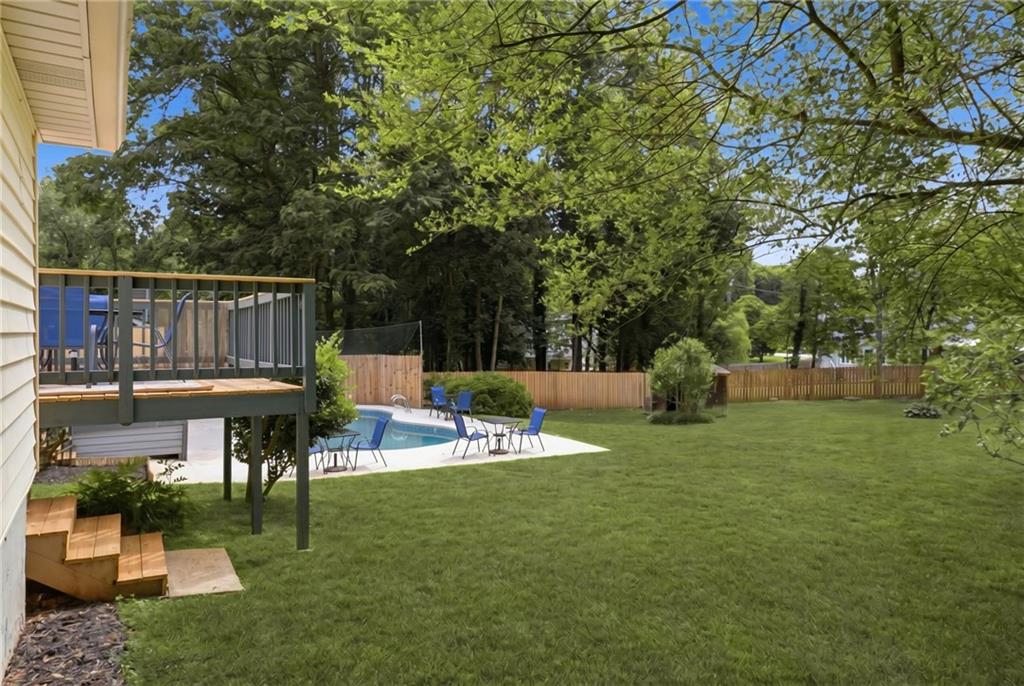 338 Arbour Way Suwanee, GA 30024 - Photo 24 of 32 a view of a chair and table on the garden