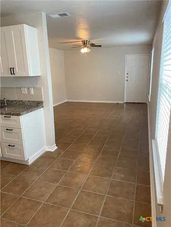 a view of a kitchen with cabinets appliances and a window