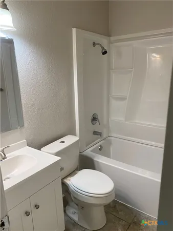 a bathroom with a toilet a sink and bathtub