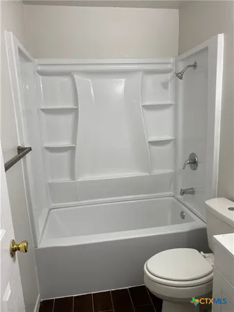a bathroom with a sink a toilet and bathtub