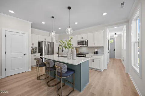 a kitchen with stainless steel appliances white cabinets and a sink