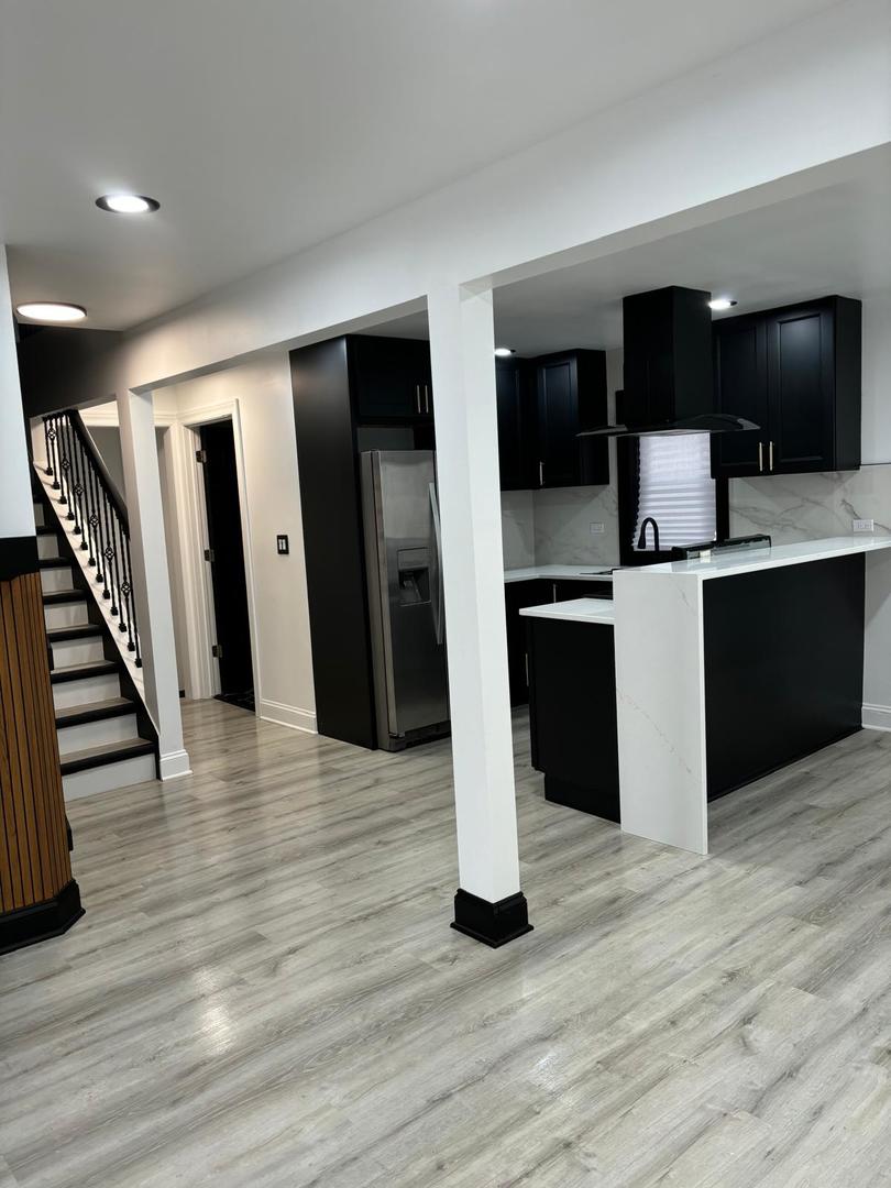 14609 Justine Street Harvey, IL 60426 - Photo 11 of 33 a view of a living room with wooden floor and stairs