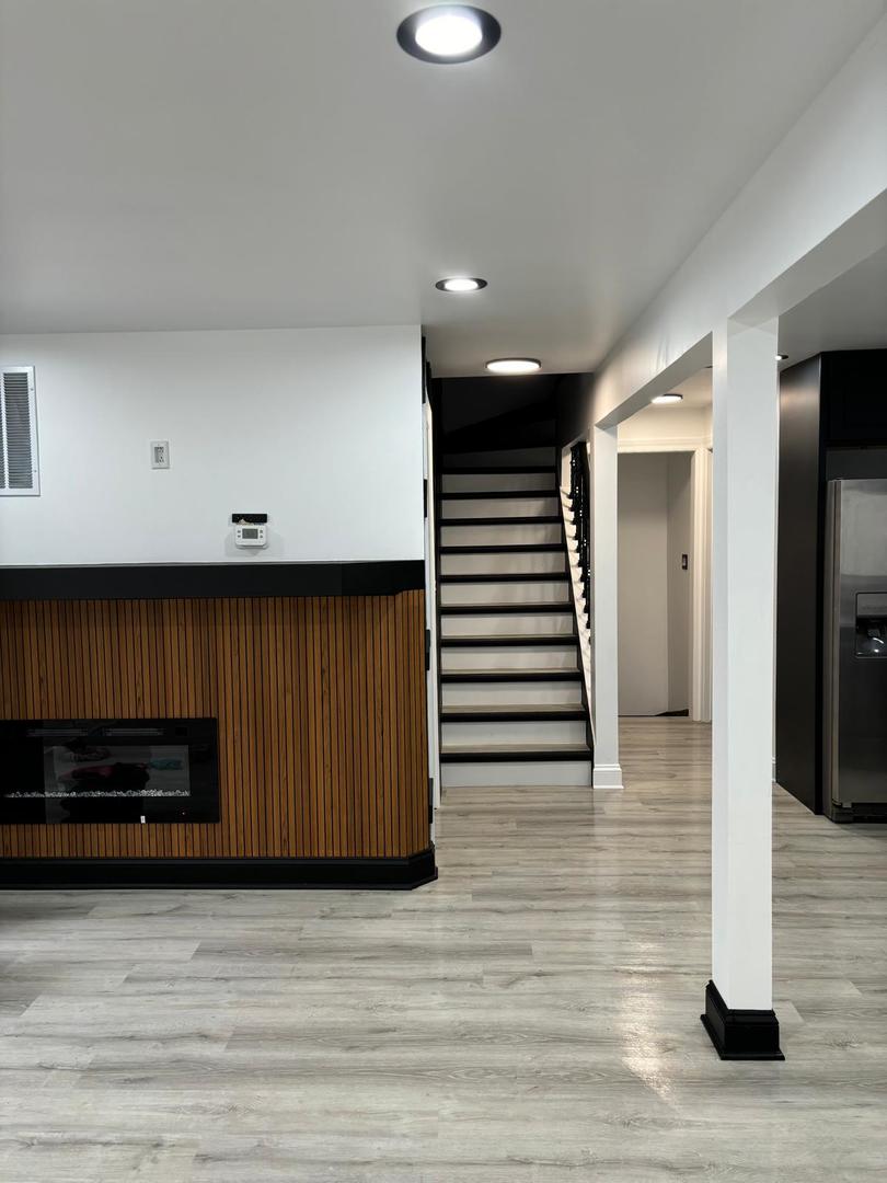 14609 Justine Street Harvey, IL 60426 - Photo 16 of 33 a view of a hallway with wooden floor and staircase
