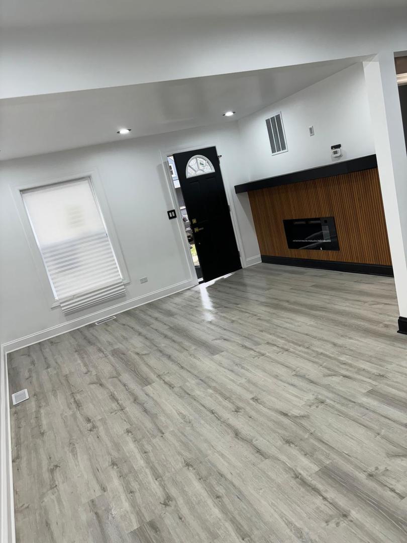 14609 Justine Street Harvey, IL 60426 - Photo 18 of 33 an empty room with wooden floor and windows