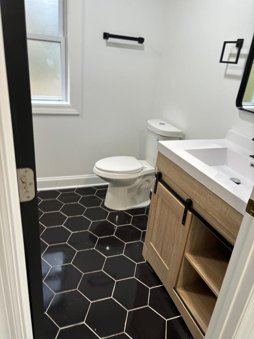 14609 Justine Street Harvey, IL 60426 - Photo 22 of 33 a bathroom with a sink toilet and a mirror