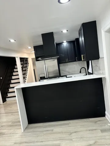 a view of kitchen with wooden floor