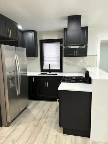 a kitchen with stainless steel appliances a sink stove and refrigerator