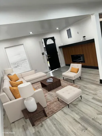 a living room with furniture and wooden floor