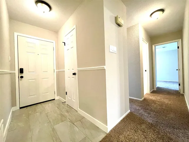an empty room with a window and a ceiling fan