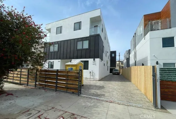 a view of a house with a wooden fence