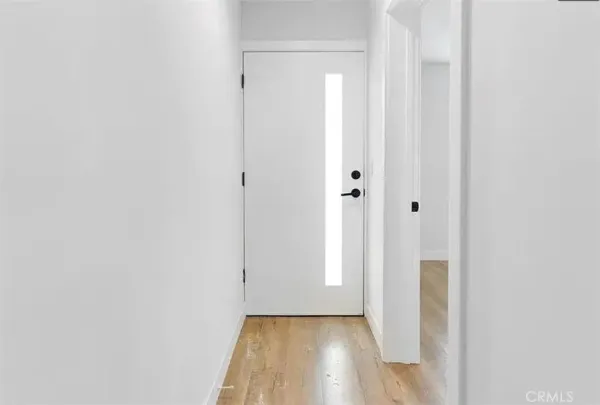 a view of a hallway with wooden floor