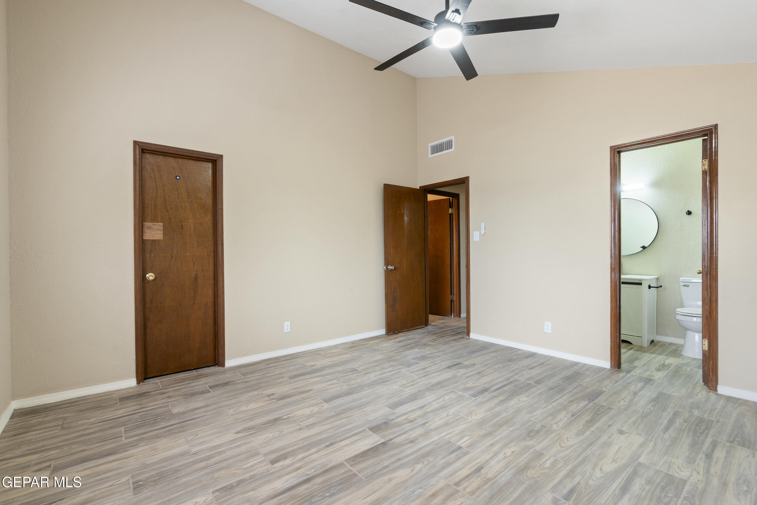 6708 Stone Court El Paso, TX 79924 - Photo 12 of 22 an empty room with wooden floor and a ceiling fan