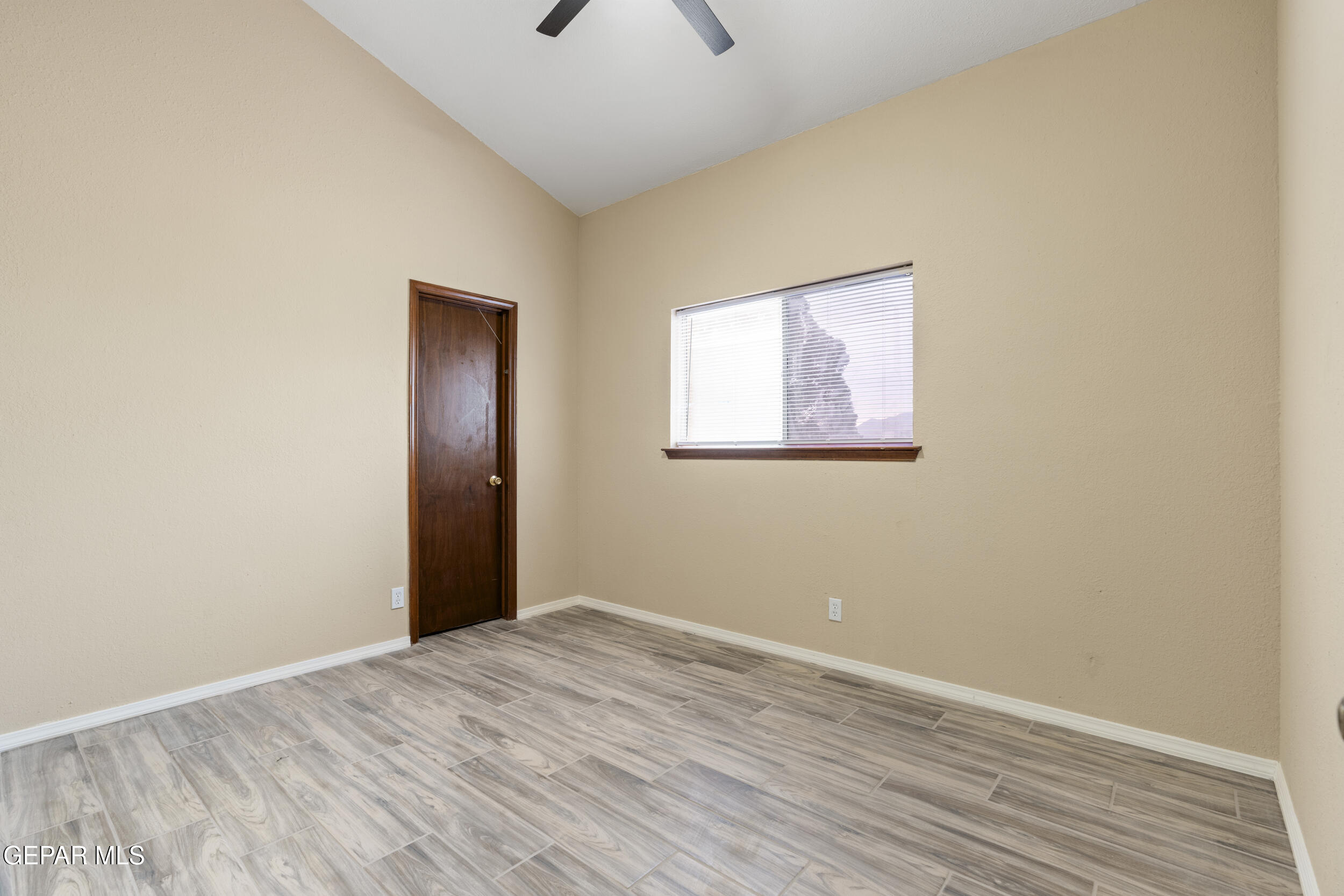 6708 Stone Court El Paso, TX 79924 - Photo 14 of 22 an empty room with wooden floor and windows