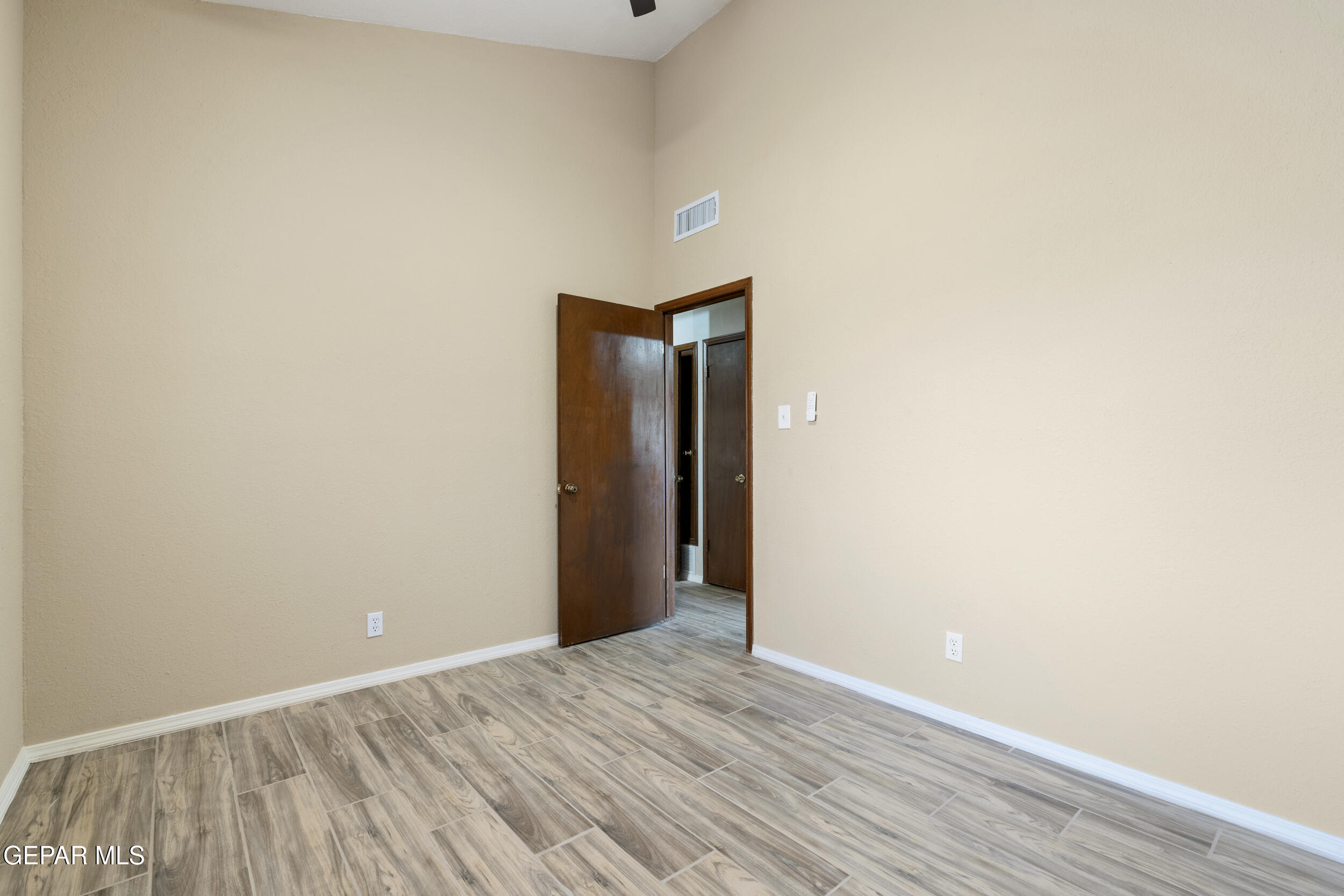 6708 Stone Court El Paso, TX 79924 - Photo 15 of 22 a view of an empty room with wooden floor and closet